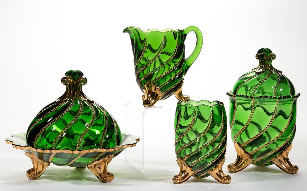 DUNCAN NO. 335 / BEADED SWIRL FOUR-PIECE TABLE SET: DUNCAN NO. 335 / BEADED SWIRL FOUR-PIECE TABLE SET, green with gilt decoration, comprising a covered butter dish, covered sugar bowl, creamer, and spooner. Geo. Duncan & Sons. Circa 1890.4 3/4" to 7 3
