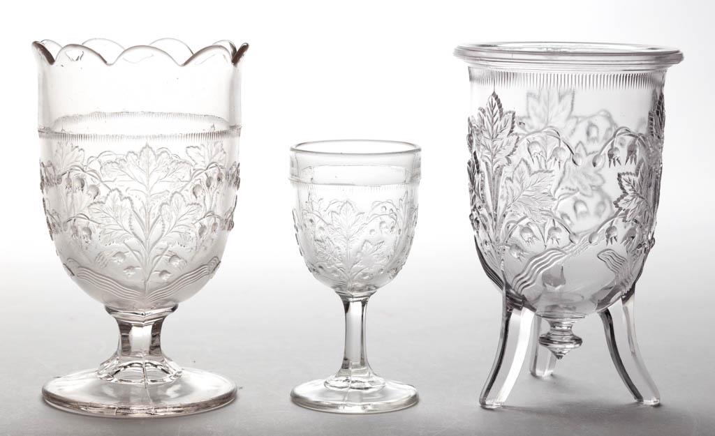 LILY OF THE VALLEY / MAY FLOWER (OMN) ARTICLES, LOT OF: LILY OF THE VALLEY / MAY FLOWER (OMN) ARTICLES, LOT OF THREE, colorless, comprising one wine and two spooners with one raised on three feet. Richards and Hartley Flint Glass Co. Fourth quarter 19th ce