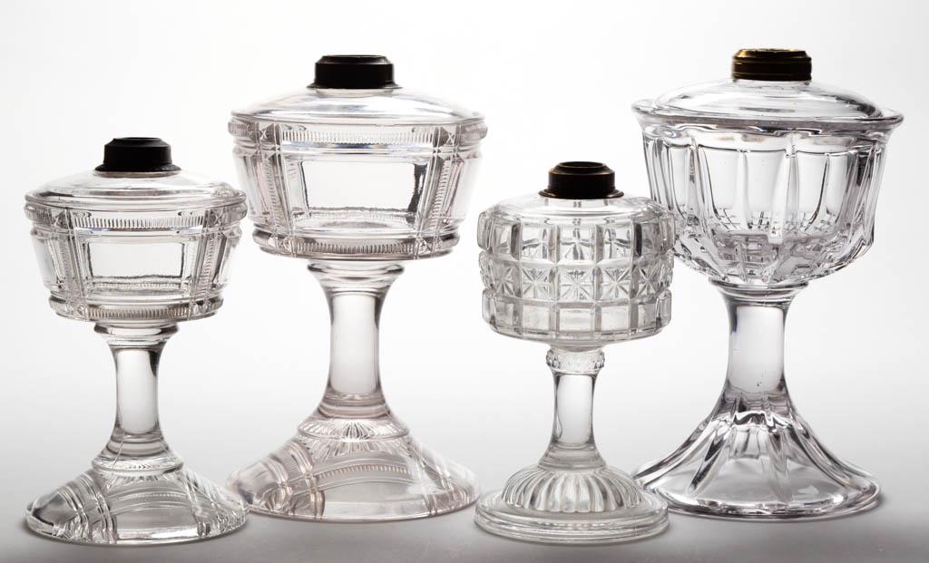 ASSORTED DUNCAN PATTERN KEROSENE STAND LAMPS, LOT OF: ASSORTED DUNCAN PATTERN KEROSENE STAND LAMPS, LOT OF FOUR, colorless, comprising one Ainslie Block, one Quarted Block, and two No. 90 / Zippered Block, No. 1 and 2 Ebling collars, and one non-original