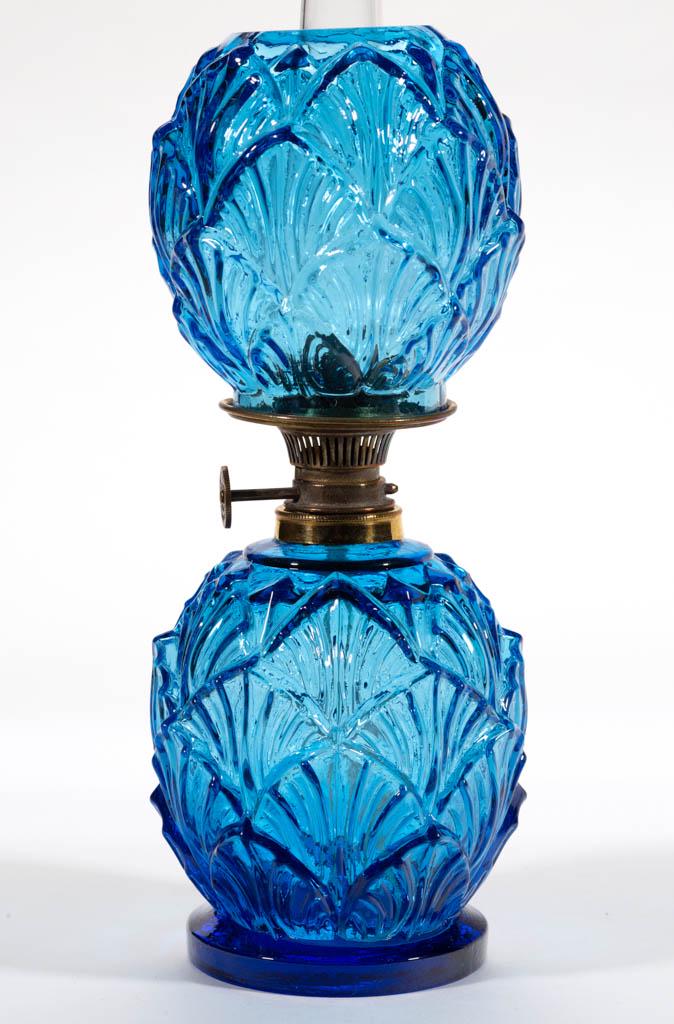 EMBOSSED OVERALL SHELL MINIATURE LAMP: EMBOSSED OVERALL SHELL MINIATURE LAMP, blue, elongated ball-form font with all-over shell pattern and a circular-form short foot, matching patterned elongated ball-form shade, period collar. Fitted wi