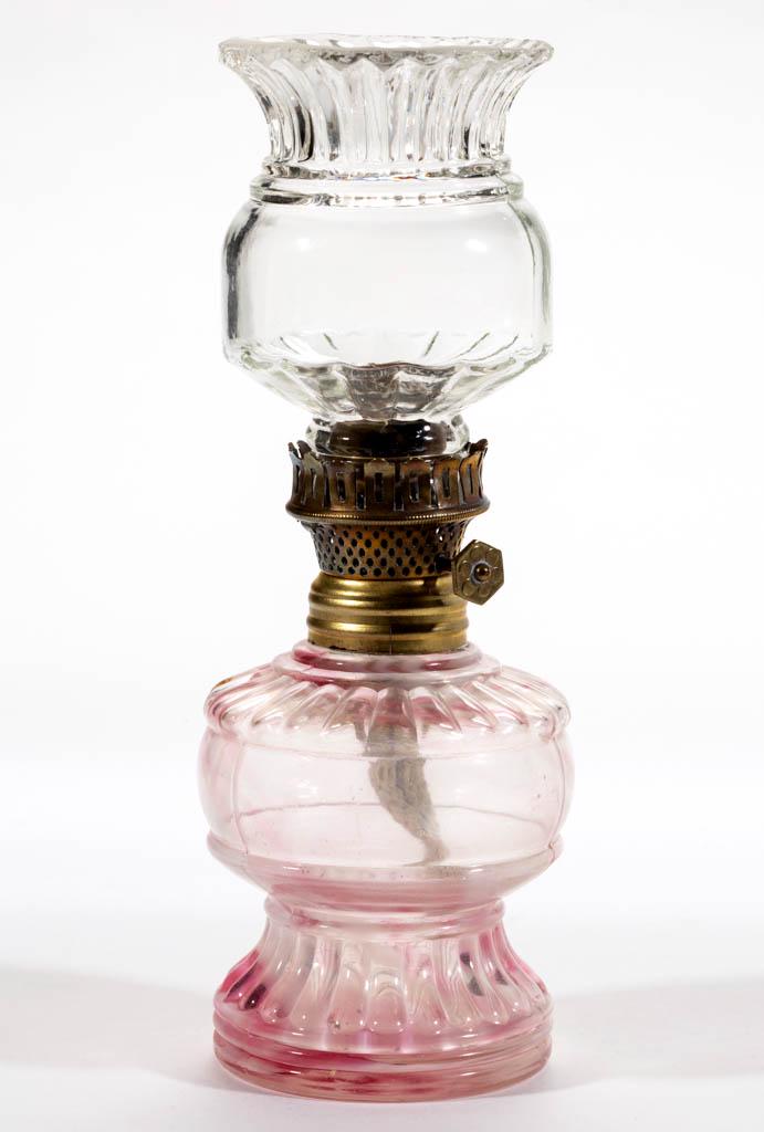 EMBOSSED RIB WITH SPATTER MINIATURE LAMP: EMBOSSED RIB WITH SPATTER MINIATURE LAMP, colorless with cranberry and opal flakes, ribbed shoulder over a plain band and ribbed pedestal foot, colorless similar patterned chimney-shade, period collar