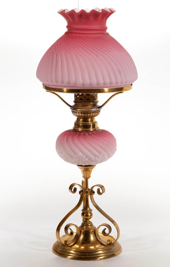 EMBOSSED RIB SWIRL AND ACANTHUS LEAF PEG MINIATURE: EMBOSSED RIB SWIRL AND ACANTHUS LEAF PEG MINIATURE BANQUET LAMP, cased dark to light rose/pink with satin finish, globular-form font with acanthus leaf band to lower body, fitted on a stamped brass ca