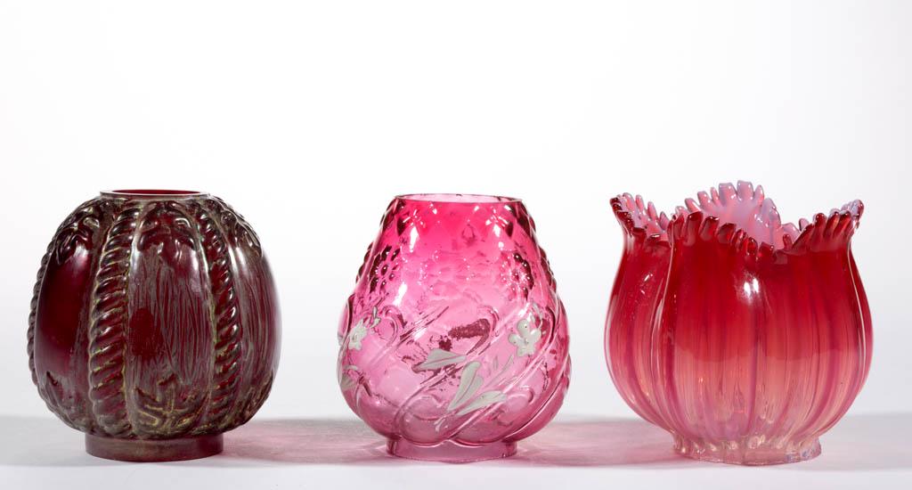 ASSORTED ART GLASS MINIATURE LAMP SHADES, LOT OF THREE: ASSORTED ART GLASS MINIATURE LAMP SHADES, LOT OF THREE, comprising a red/ruby embossed rope and leaf/Smith I, fig. 423 with yellow decoration, 2" D fitter; a cranberry rib swirl/Smith I, fig. 446 with