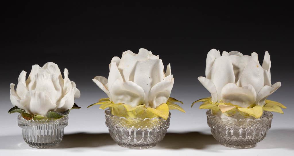 GERMAN BISQUE FLORIFORM FAIRY LAMPS, LOT OF THREE: GERMAN BISQUE FLORIFORM FAIRY LAMPS, LOT OF THREE, comprising a wee-size dome and two pyramid-size domes, each central upright flower with lower downturned leaves, each with appropriate lamp cup, two 