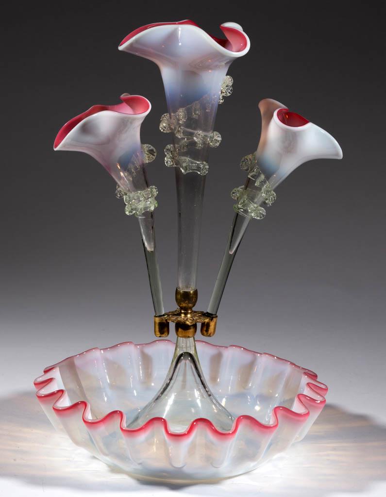 VICTORIAN OPALESCENT RUBINA VERDE GLASS EPERGNE: VICTORIAN OPALESCENT RUBINA VERDE GLASS EPERGNE, fitted with three vases with applied pale green (reacts under black light) rigaree, swirling opalescent base, metal mount/vase holder. Fourth quarter 1