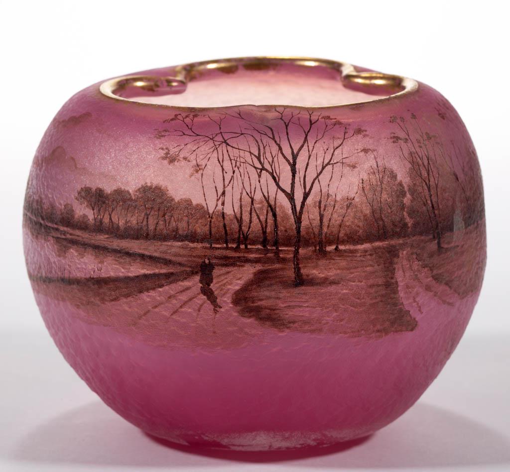 DAUM NANCY ENAMEL-DECORATED ART GLASS ROSE BOWL: DAUM NANCY ENAMEL-DECORATED ART GLASS ROSE BOWL, pink with gilt decoration, decoration depicting country roads adjacent to a lake with flying ducks, trefoil mouth, polished pontil mark, signed "DAUM/N