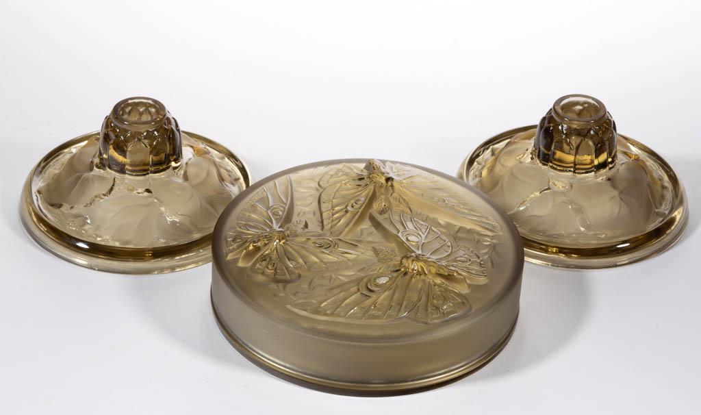 VERLYS ART GLASS ARTICLES, LOT OF THREE: VERLYS ART GLASS ARTICLES, LOT OF THREE, Topaz, comprising a Butterfly bonbon dish, and a pair of Water Lily candlesticks, each signed "Verlys". Circa 1935. Butterfly: 2 1/8" H, 6 1/2" D. Candlesticks