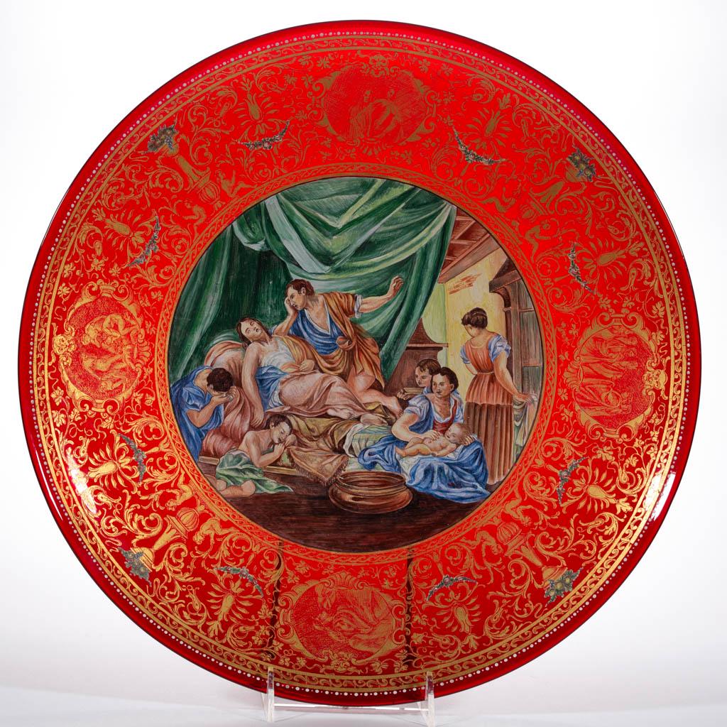 VENETIAN RENAISSANCE-STYLE WEDDING CHARGER: VENETIAN RENAISSANCE-STYLE WEDDING CHARGER, ruby with fine polychrome-enamel decoration, central design appears to depict a family mourning a mother's death after child birth, ornate band of gilt enam