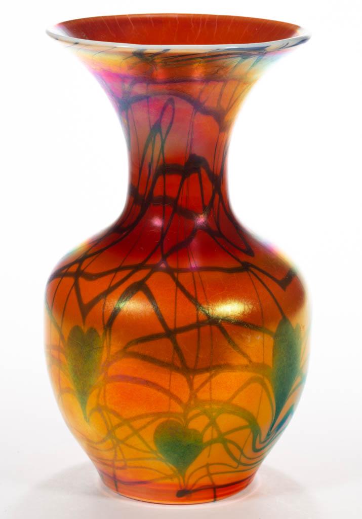 IMPERIAL FREE HAND HEART AND VINE ART GLASS VASE: IMPERIAL FREE HAND HEART AND VINE ART GLASS VASE, orange iridescent with blue decoration, globular form with a flaring neck, orange iridescent interior, polished pontil mark. Imperial Glass Co. Circa 
