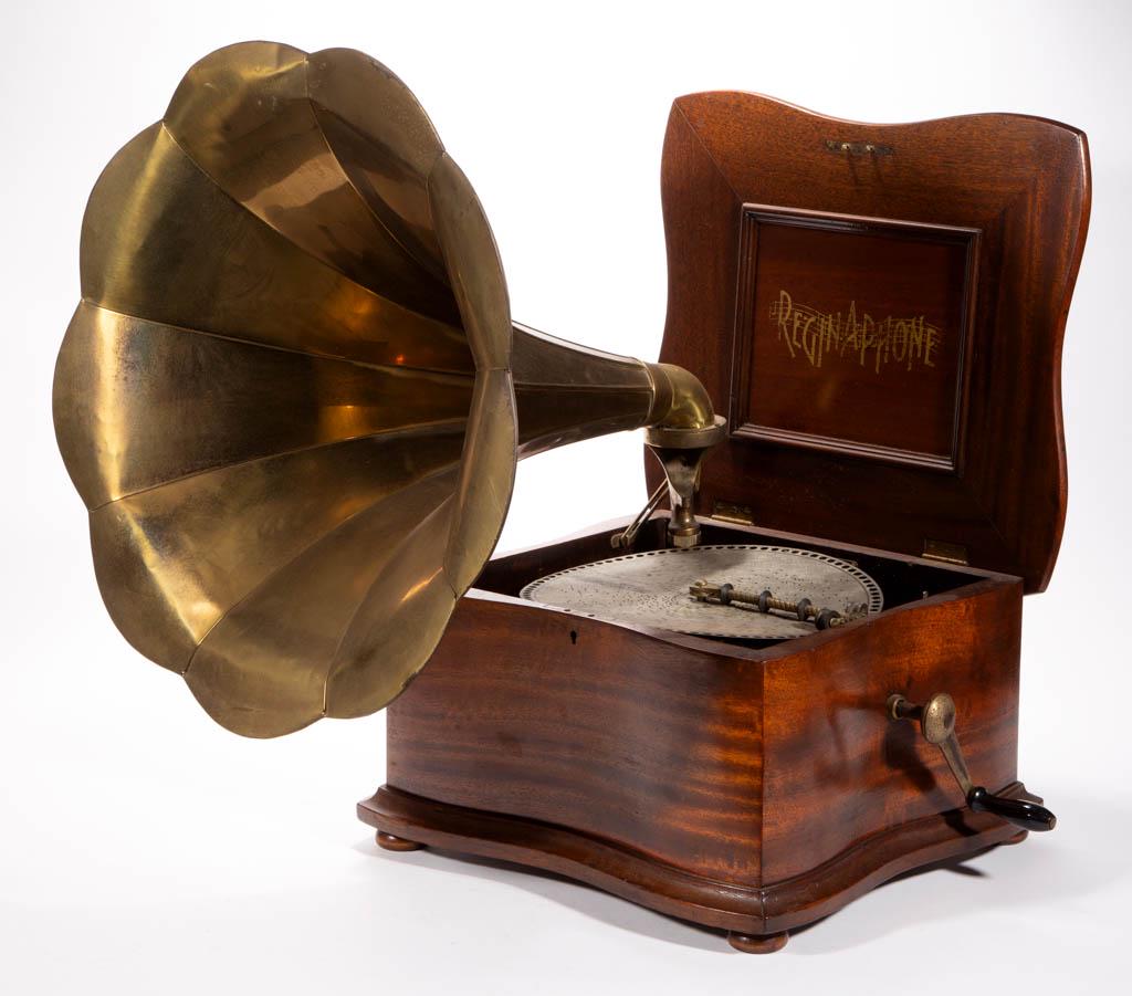 REGINAPHONE STYLE 150 MUSIC BOX: REGINAPHONE STYLE 150 MUSIC BOX, mahogany case, stamped on interior plaque "No. 1720088", with crank and morning glory horn. Retains probably original finish. Circa 1900. 15 1/2" x 17 1/4" cabinet.Ver