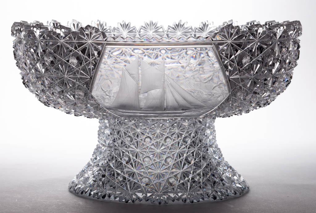AMERICAN "RUSSIAN" PATTERN BRILLIANT CUT AND ENGRAVED: AMERICAN "RUSSIAN" PATTERN BRILLIANT CUT AND ENGRAVED GLASS PEDESTAL PUNCH BOWL, colorless. in two parts, the large, shallow bowl with a central reserve depicting the schooner Montauk sailing with sea