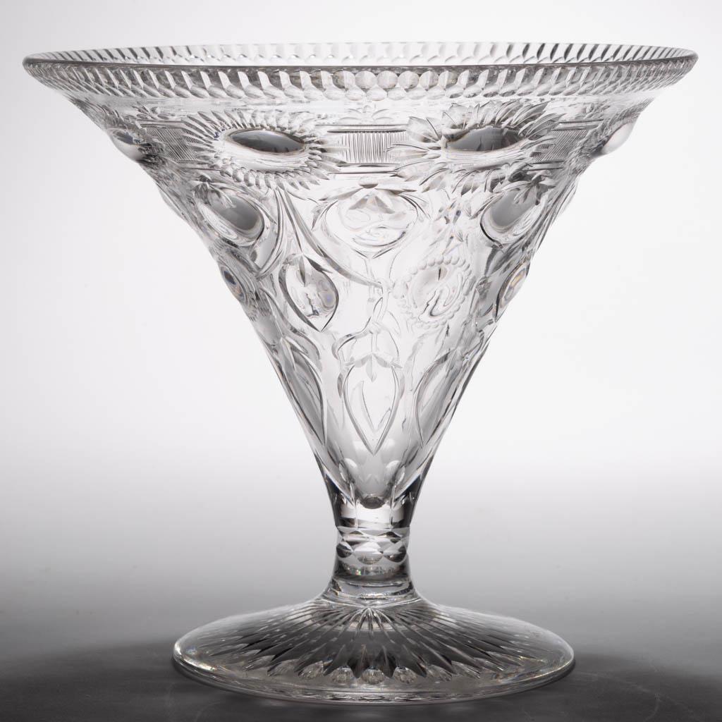 SIGNED WEBB CUT GLASS VASE: SIGNED WEBB CUT GLASS VASE, colorless, wide trumpet form with a circular foot with prism and thumbprint decoration to the underside, acid-stamped signature to the stem. Thomas Webb & Sons. First quart