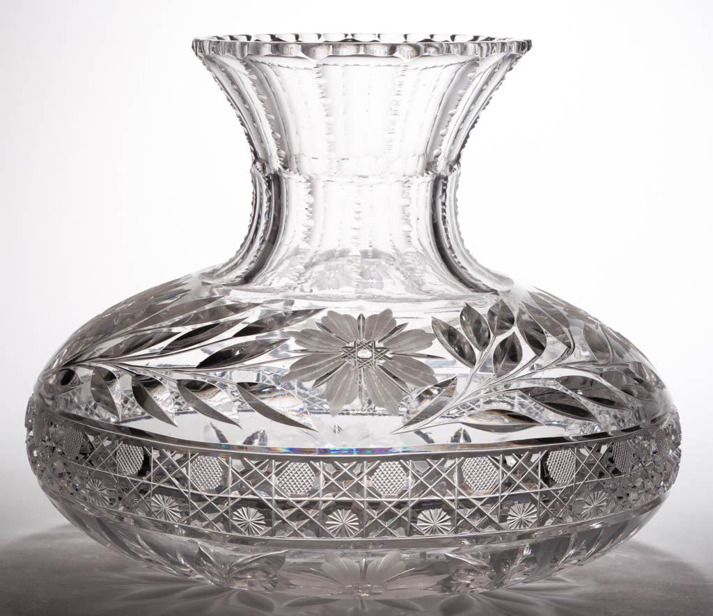 AMERICAN CUT GLASS LARGE FLOWER CENTER VASE: AMERICAN CUT GLASS LARGE FLOWER CENTER VASE, colorless, squat bulbous form with floral shoulder and base, notched rim. Possibly Fry or Pairpoint. First quarter 20th century. 9 1/2" H, 6 1/4" D rim, 12
