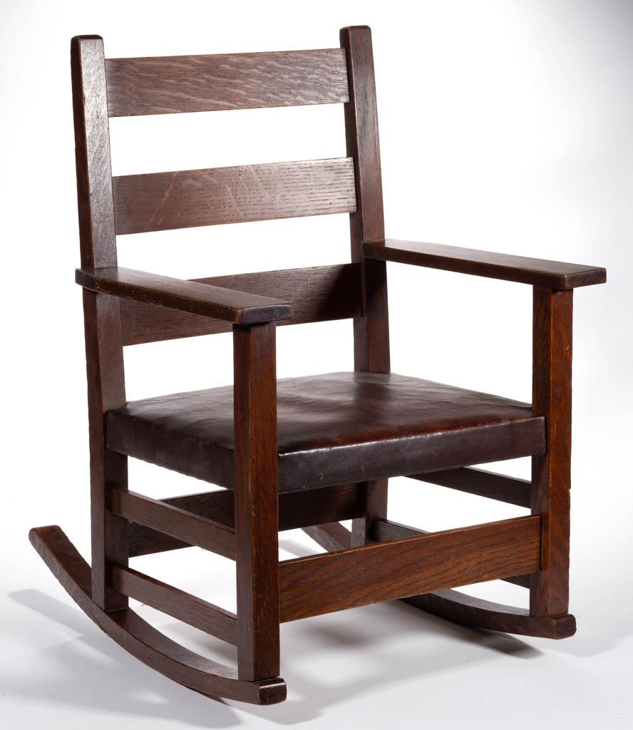 GUSTAV STICKLEY OAK MODEL 343 CHILD'S ROCKER: GUSTAV STICKLEY OAK MODEL 343 CHILD'S ROCKER, with "Als Ik Kan" marked to back stretcher, retains likely original leather seat. Retains probably original finish with warm color. Circa 1915. 10 3/4" H 