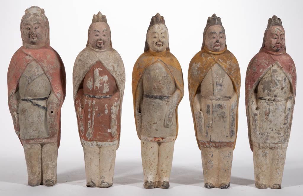 CHINESE EARTHENWARE TOMB FIGURES, LOT OF FIVE: CHINESE EARTHENWARE TOMB FIGURES, LOT OF FIVE, each of a standing official wearing a peaked hat, a cape, and a belted tunic, featuring a hole in top of one hand, hollow interior, and pigment remnants.