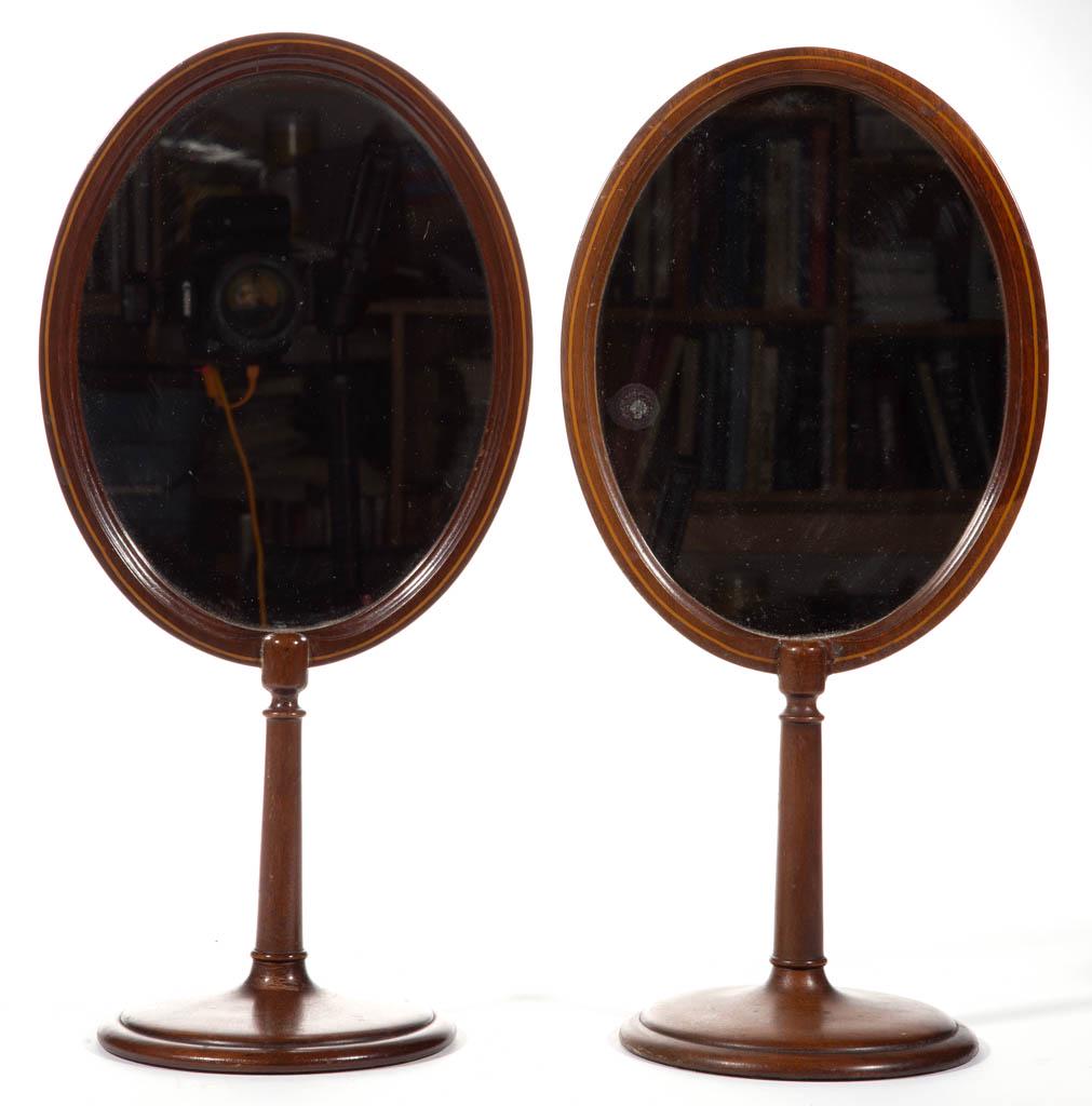 PAIR OF INLAID MAHOGANY TABLE MIRRORS: PAIR OF INLAID MAHOGANY TABLE MIRRORS, each oval form raised on a turned standard and circular base. Late 19th/early 20th century. Each 17 1/2" H.Each in very good overall condition with very minor we