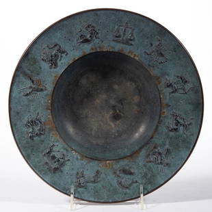 FRITZ NUSS ZODIAC BRONZE BOWL: FRITZ NUSS ZODIAC BRONZE BOWL, original patina, bowl showing zodiac signs around the indention, signed to the top "NUSS '46". 1946. 1 1/4" H, 10 1/2" D rim.Undamaged.
