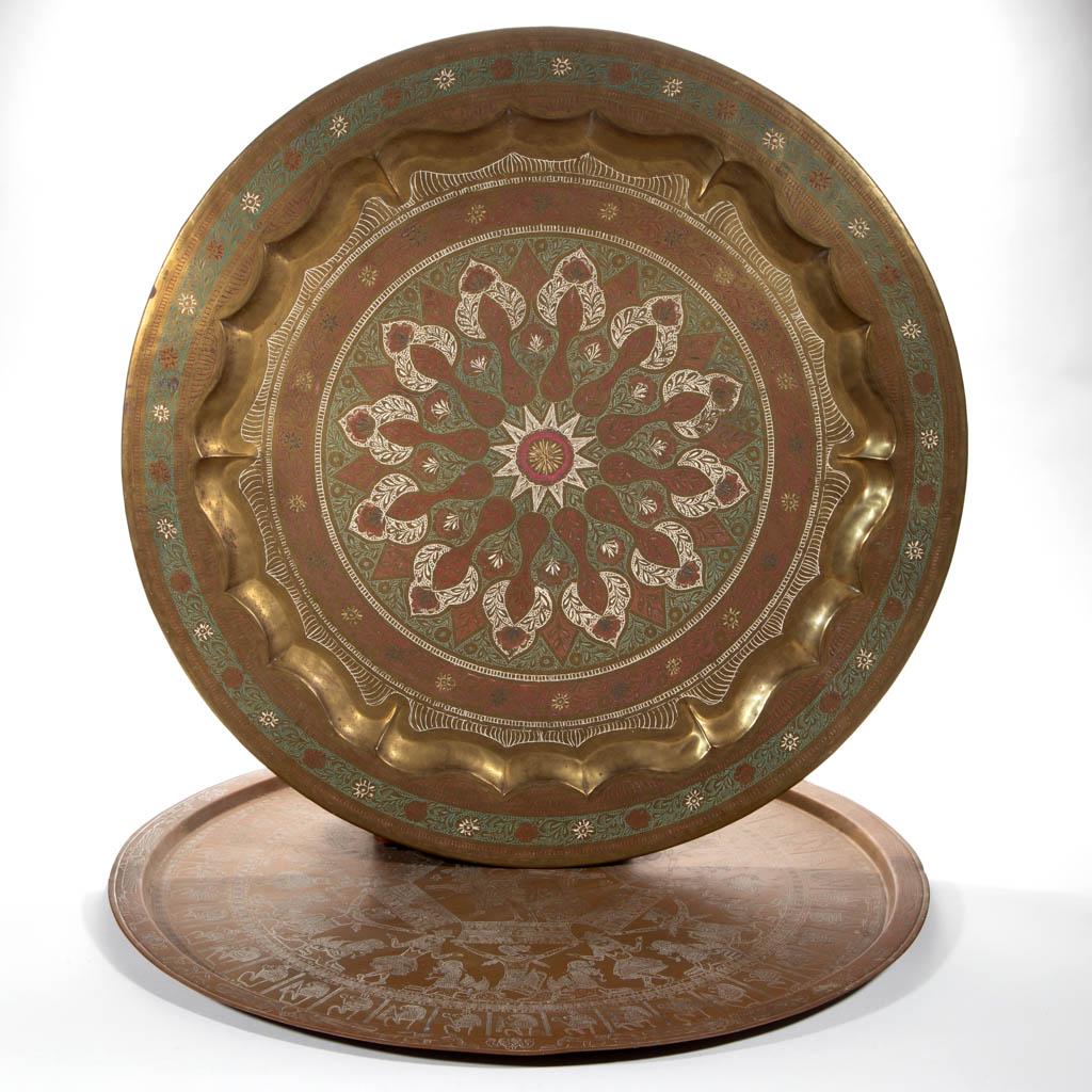 EGYPTIAN COPPER LARGE TRAY / PLATTER: EGYPTIAN COPPER LARGE TRAY / PLATTER, featuring hieroglyphic decoration. Together with a hanging brass tray with painted decoration. Two pieces total. 20th century. 27 1/4" and 28 1/2" D.Very good ove