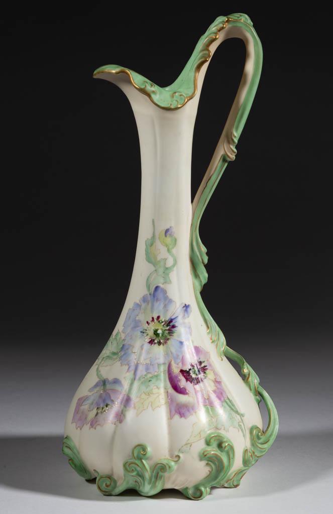FRENCH / AMERICAN PAIRPOINT LIMOGES PORCELAIN ART: FRENCH / AMERICAN PAIRPOINT LIMOGES PORCELAIN ART NOUVEAU EWER, featuring pastel polychrome hand-painted floral motif on cream ground with molded light green vine-like handle, and gilt highlights. Mar