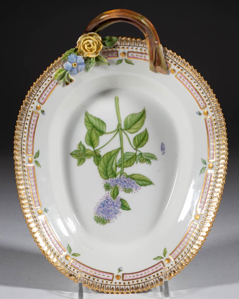 DANISH ROYAL COPENHAGEN "FLORA DANICA" SERVING DISH: DANISH ROYAL COPENHAGEN "FLORA DANICA" SERVING DISH, oval-shaped with molded twig handle, featuring hand-painted lavender and green water mint flower with gilt crenellated rim and applied floral decor