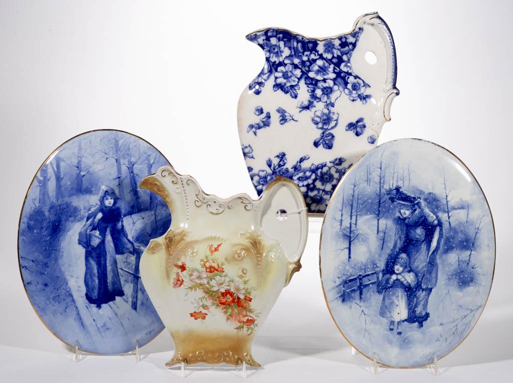 ENGLISH STAFFORDSHIRE FLOW BLUE CERAMIC WALL PLAQUES,: ENGLISH STAFFORDSHIRE FLOW BLUE CERAMIC WALL PLAQUES, LOT OF THREE, comprising two oval examples featuring charming winter scenes of figures walking in snow, signed "A.E. Simpson" and "P. Jones", with