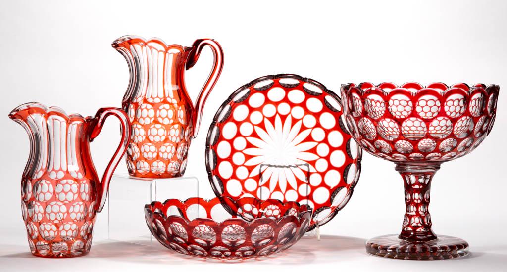 FINE AMERICAN CUT OVERLAY PUNTY FIVE-PIECE GARNITURE: FINE AMERICAN CUT OVERLAY PUNTY FIVE-PIECE GARNITURE SET, ruby to colorless, comprising an open compote, two pitchers with applied overlay handles, and two bowls, each with a scalloped rim and a rayed