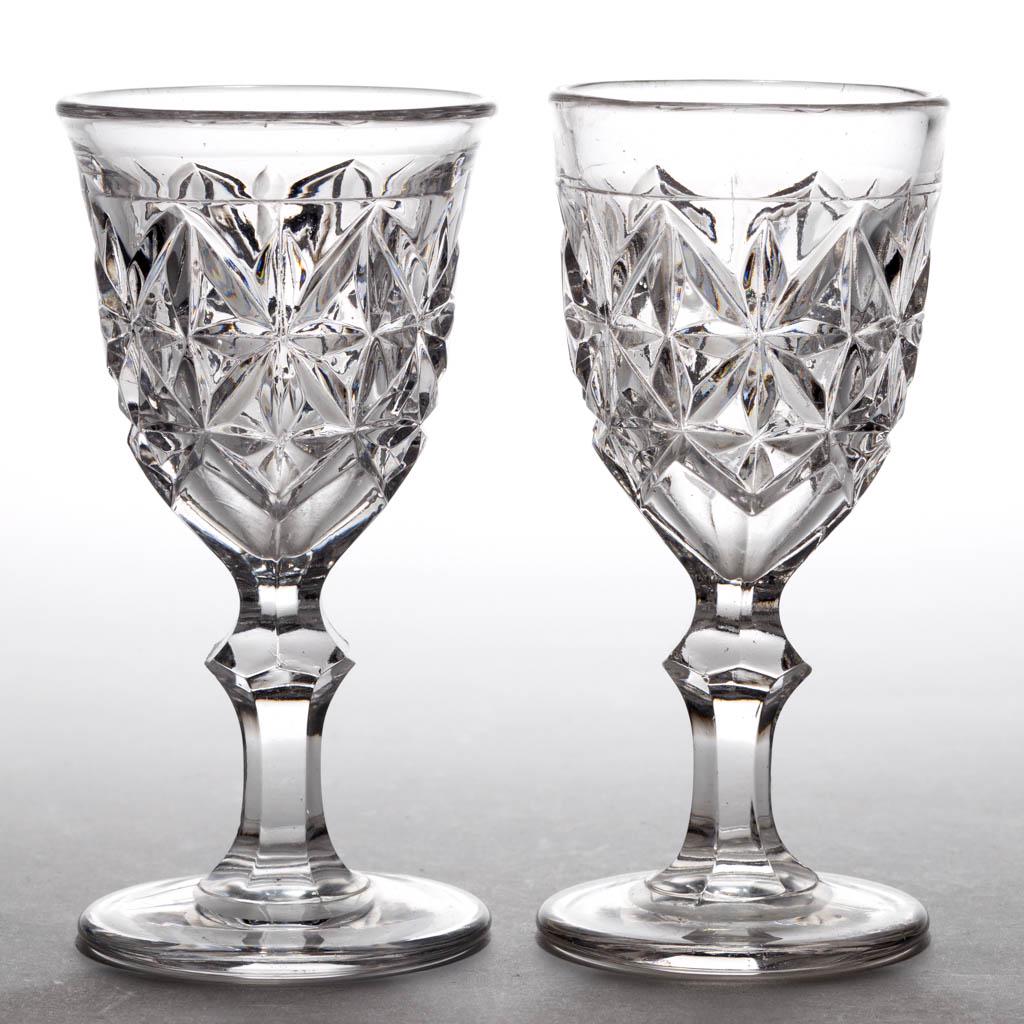 SANDWICH STAR / QUARTER DIAMOND (OMN) WINES, LOT OF TWO: SANDWICH STAR / QUARTER DIAMOND (OMN) WINES, LOT OF TWO, colorless lead glass, polished pontil marks. Boston & Sandwich Glass Co. 1845-1865. 4 5/8" H, 2 1/8" and 2 3/8" D rims, 2 1/4" D feet. One unda