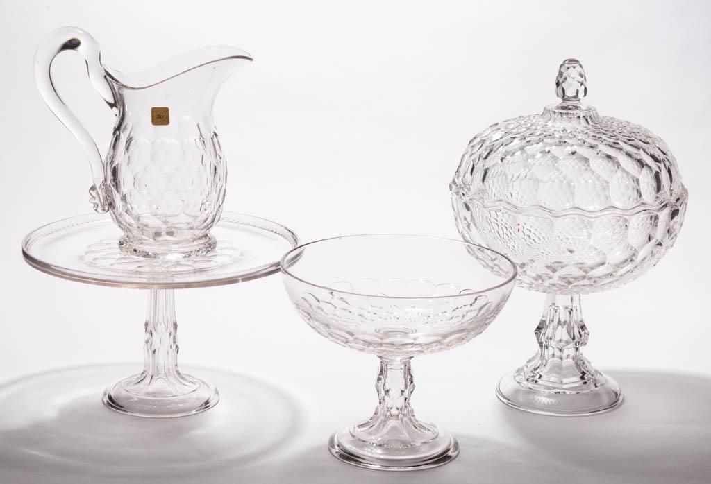 ASSORTED PRESSED HONEYCOMB ARTICLES, LOT OF FOUR: ASSORTED PRESSED HONEYCOMB ARTICLES, LOT OF FOUR, colorless, comprising a Vernon Honeycomb covered compote, a New York Honeycomb cake stand, open compote, and water pitcher. Various makers. Second hal