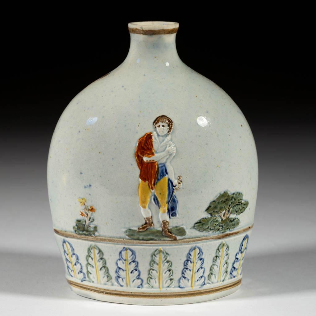 ENGLISH PEARLWARE / PRATTWARE CERAMIC FLASK: ENGLISH PEARLWARE / PRATTWARE CERAMIC FLASK, featuring bold polychrome relief images of a man holding a dagger with reverse having a shrouded woman holding a small flame, with vertical acanthus leaves