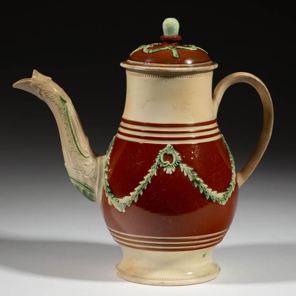 ENGLISH STAFFORDSHIRE CREAMWARE CERAMIC COFFEE POT AND: ENGLISH STAFFORDSHIRE CREAMWARE CERAMIC COFFEE POT AND COVER, having baluster shape with molded spout, featuring applied foliate swag decoration with green highlights and beaded rim and base. Unmarked