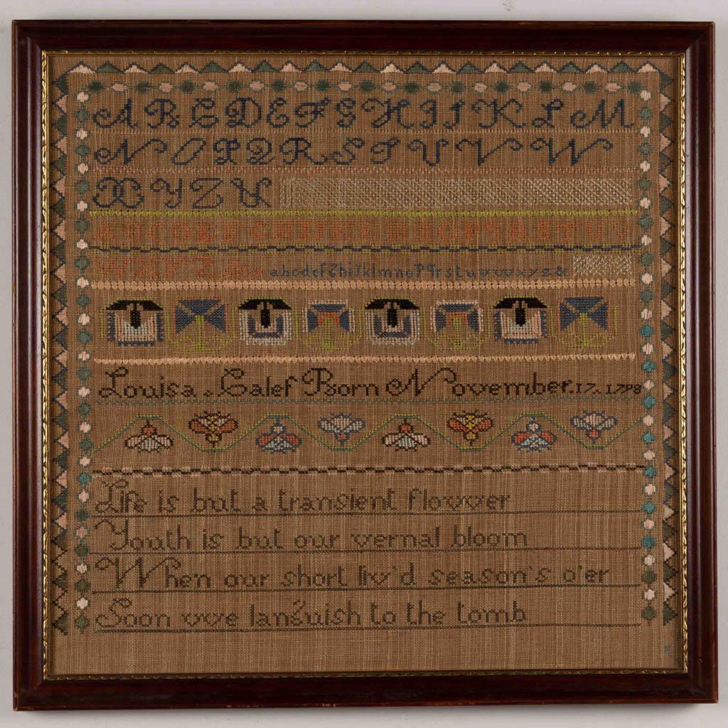 AMERICAN NEEDLEWORK SAMPLER: AMERICAN NEEDLEWORK SAMPLER, silk on linen, five alphabet rows above two flower vine rows bordering "Louisa . Calef Born November. 17 1798" divided by decorative stitching, lower third with a verse of
