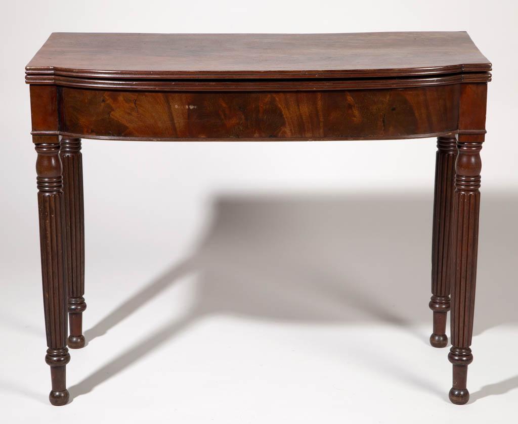 AMERICAN MAHOGANY CARD / GAME TABLE: AMERICAN MAHOGANY CARD / GAME TABLE, shaped, hinged folding top, concealing open interior on one side, raised on reeded legs. Retains an old refinished surface with warm color. Possibly Baltimore, Mar
