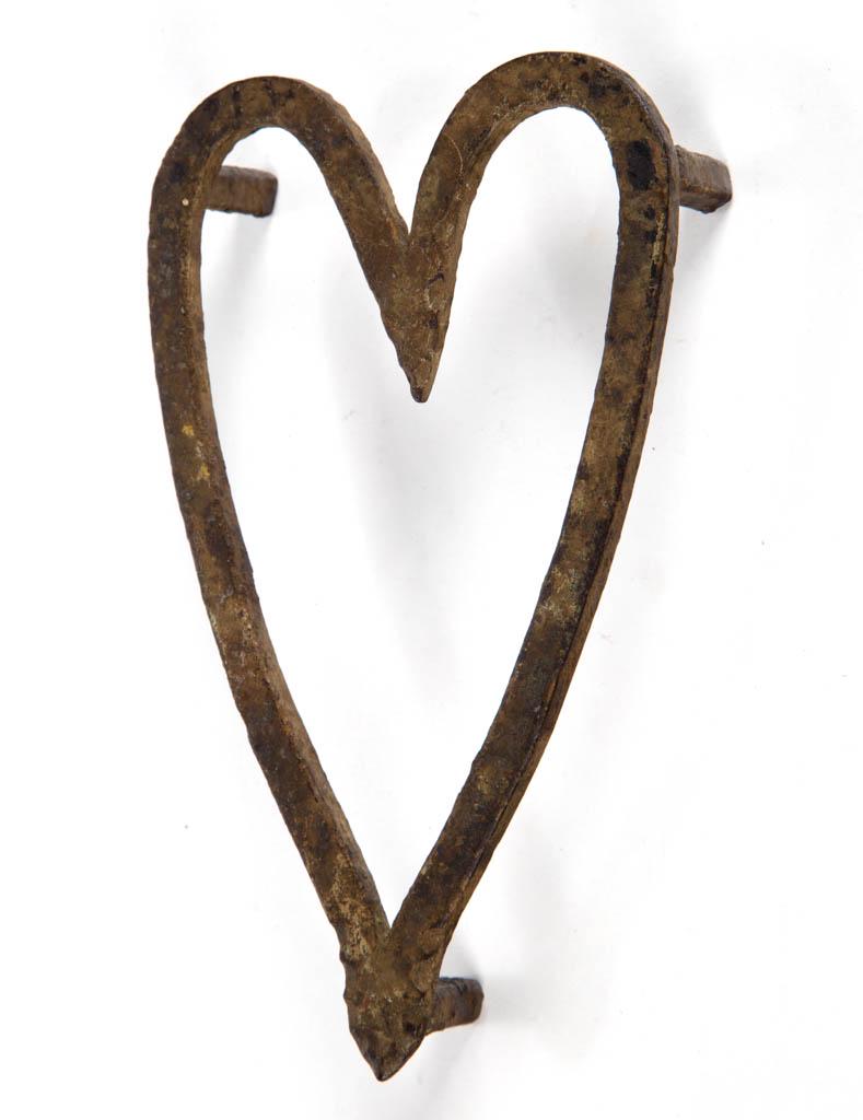 VALLEY OF VIRGINIA WROUGHT-IRON TRIVET: VALLEY OF VIRGINIA WROUGHT-IRON TRIVET, heart-form raised on simple square feet. Old dull gold-painted surface. Found in Floyd Co., VA. Mid 19th century. 1 1/4" H, 6 1/2" x 3 3/4".Very good condition