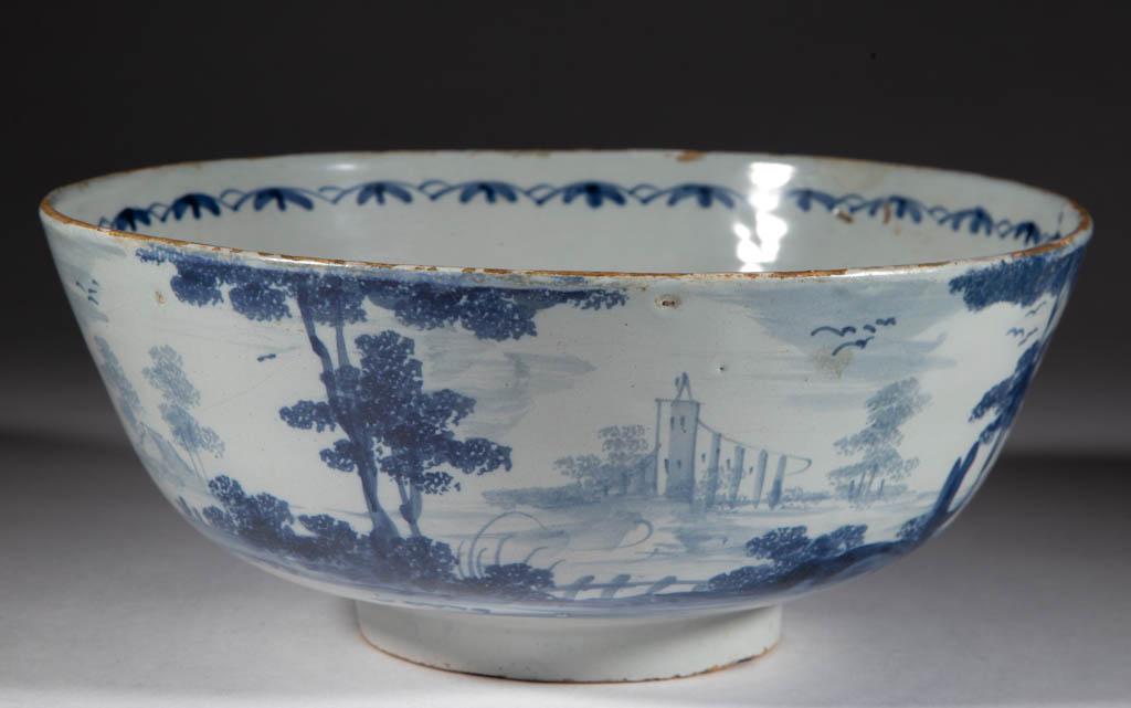 ENGLISH DELFT TIN-GLAZED EARTHENWARE BOWL: ENGLISH DELFT TIN-GLAZED EARTHENWARE BOWL, featuring blue hand-painted images of a man flying a kite in a continuous landscape featuring a church with steeple, homes, and a tall sweeping building, hav