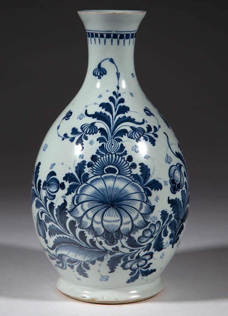 ENGLISH DELFT BLUE AND WHITE TIN-GLAZED EARTHENWARE: ENGLISH DELFT BLUE AND WHITE TIN-GLAZED EARTHENWARE WATER BOTTLE / EWER / GUGLET, ovoid form with cut foot rim, slender, tapered neck, and large bold floral designs on sides and small geometric design