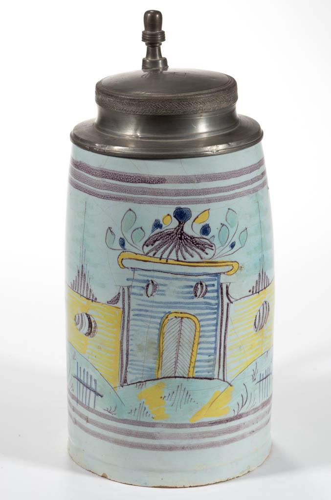 DUTCH DELFT TIN-GLAZED EARTHENWARE TANKARD: DUTCH DELFT TIN-GLAZED EARTHENWARE TANKARD, cylindrical form, featuring a polychrome hand-painted fort-like structure with wall to front, and hinged pewter lid, inscribed "G H". Circa 1780. 9 3/4" HOA