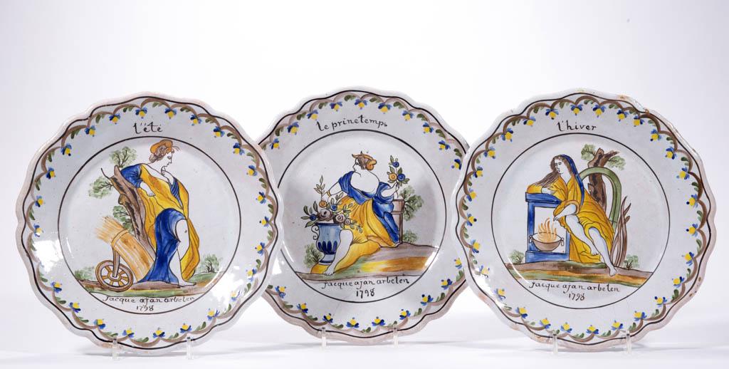 FRENCH FAIENCE TIN-GLAZED EARTHENWARE PLATES, LOT OF: FRENCH FAIENCE TIN-GLAZED EARTHENWARE PLATES, LOT OF THREE, having bold polychrome hand-painted images of reclining women portraying "le prinetemps" (spring), "l'ete" (summer), and "l'hiver" (winter),