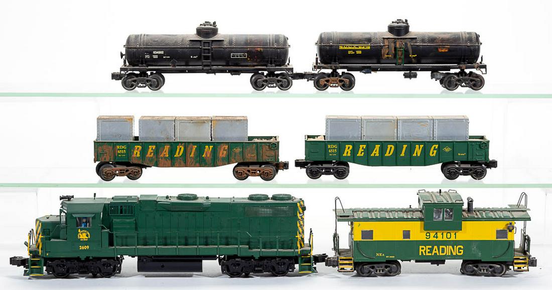 ASSORTED K-LINE O-GAUGE CARS, LOT OF 11: ASSORTED K-LINE O-GAUGE CARS, LOT OF 11, including a No. 2609 Central Railroad Co. locomotive with original box, a Maersk trailer on flat car, a No. 94101 Reading caboose, three No. 6169 Leigh Valley 