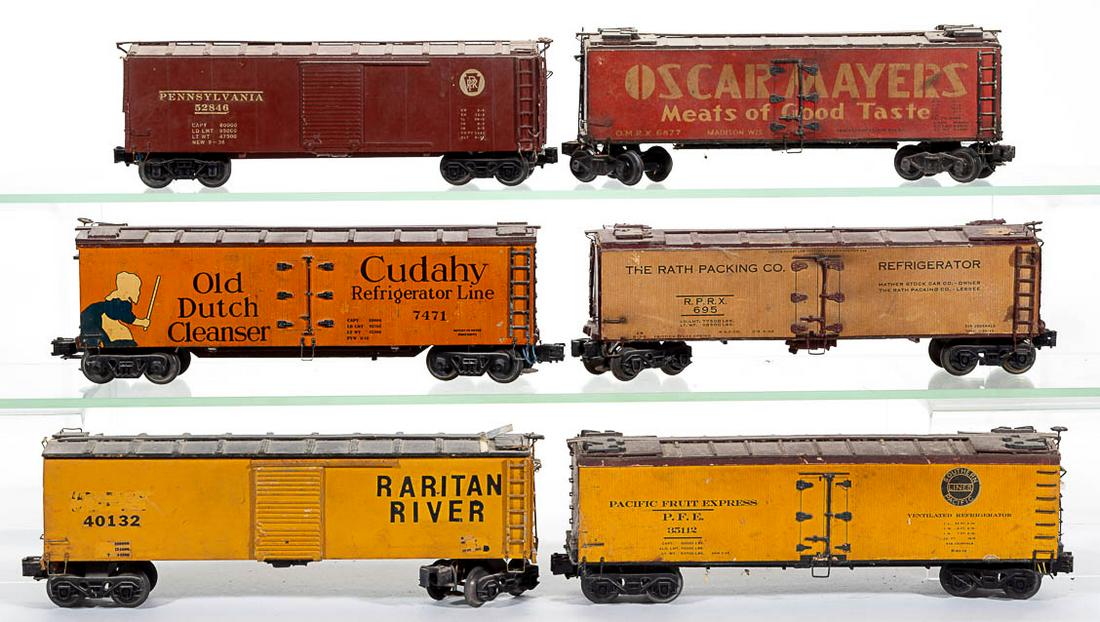 ASSORTED O-GAUGE FREIGHT CARS, LOT OF SIX: ASSORTED O-GAUGE FREIGHT CARS, LOT OF SIX, wood and metal, including Oscar Mayer, Old Dutch Cleanser, and Pacific Fruit Express. Possibly Westbrook. First half 20th century. Oscar Mayer 11" LOA. Fair 