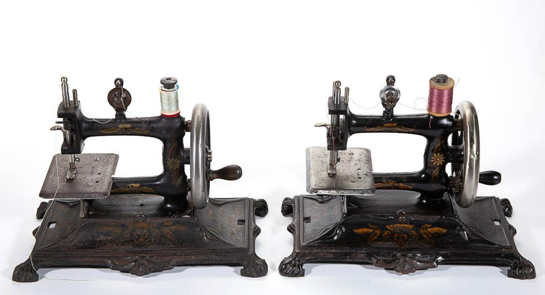 MULLER MODEL NO. 12 CAST-IRON CHILD'S TOY SEWING: MULLER MODEL NO. 12 CAST-IRON CHILD'S TOY SEWING MACHINES, LOT OF TWO, each having stenciled decoration, one with sewing machine that tilts to reveal a small storage compartment for accessories and to