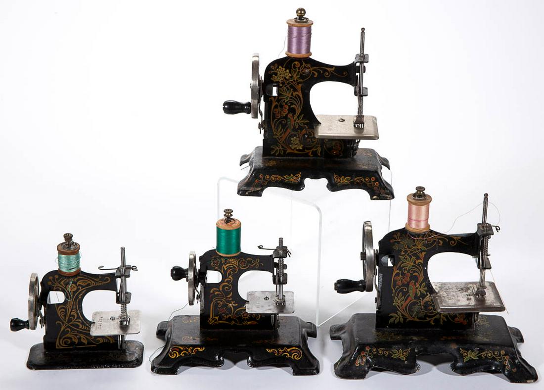GERMAN AND PRUSSIA METAL CHILD'S TOY SEWING MACHINES,: GERMAN AND PRUSSIA METAL CHILD'S TOY SEWING MACHINES, LOT OF FOUR, each with stenciled decoration. Three with "Made in Germany" mark, one with "Prussia" mark, largest example marked with "Little Beaut