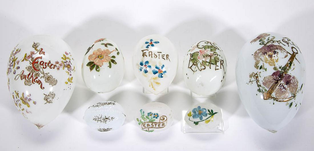 ASSORTED OPAQUE GLASS EASTER EGGS, LOT OF EIGHT: ASSORTED OPAQUE GLASS EASTER EGGS, LOT OF EIGHT, opaque white/milk glass with polychrome-enamel decoration, each ovoid form, some pieces with embossed surfaces. Together with three bundles of grass. 1