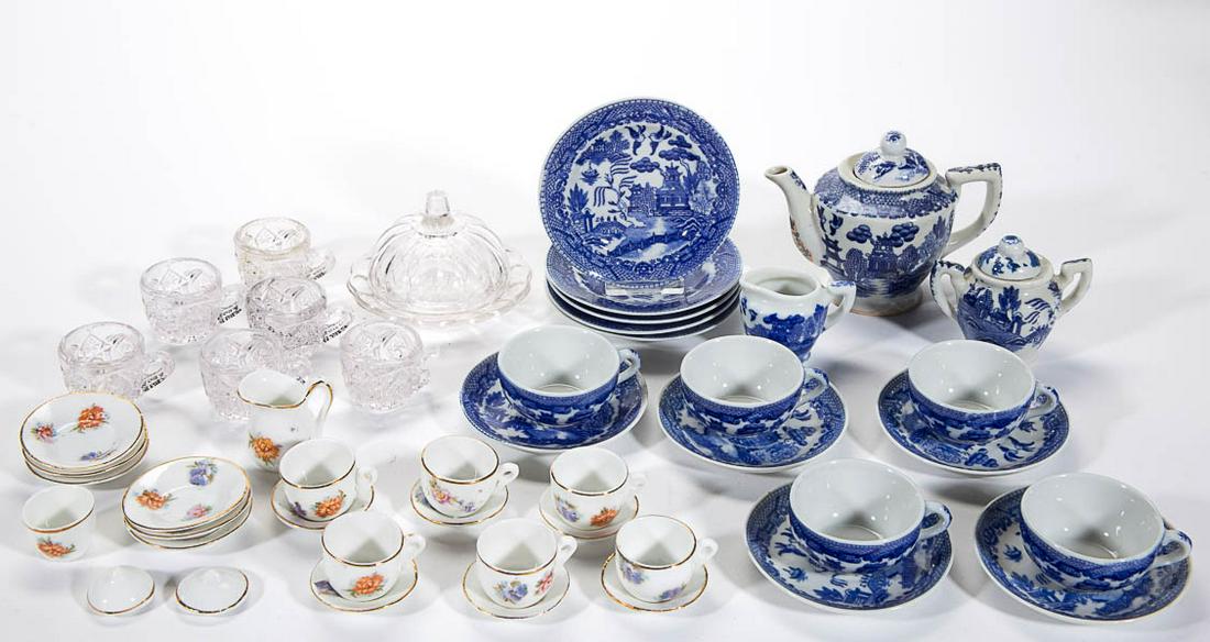 ASSORTED CERAMIC AND GLASS CHILDREN'S TOY TABLE: ASSORTED CERAMIC AND GLASS CHILDREN'S TOY TABLE ARTICLES, LOT OF 47, comprising six colorless punch cups, a colorless covered butter dish, a 22-piece set having polychrome floral decals, and a 18-piec