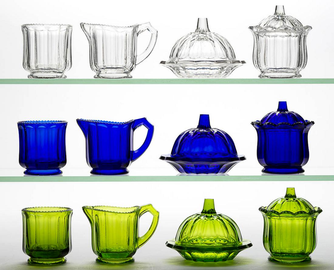 COLONIAL CHILDREN: COLONIAL CHILDREN'S GLASS TOY FOUR-PIECE TABLE SETS, LOT OF THREE, cobalt blue, green, and colorless, each comprising a covered butter dish, covered sugar bowl, creamer, and spooner. Cambridge Glass C