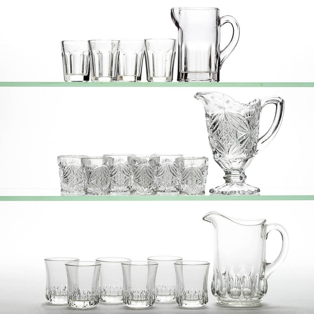 ASSORTED PRESSED CHILDREN: ASSORTED PRESSED CHILDREN'S GLASS TOY WATER SETS, LOT OF THREE, colorless, comprising a seven-piece Pattee Cross, a seven-piece Optic, and a five-piece Colonial. Various makers. Fourth quarter 19th/fi