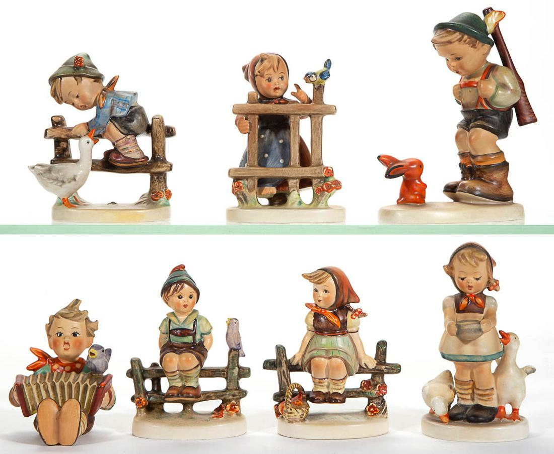 GERMAN GOEBEL HUMMEL CERAMIC FIGURES, LOT OF SEVEN: GERMAN GOEBEL HUMMEL CERAMIC FIGURES, LOT OF SEVEN, comprising a boy with rifle slung over shoulder gazing at orange rabbit (#6/0, TMK-2), a girl standing behind a fence with bird perched on top (#203
