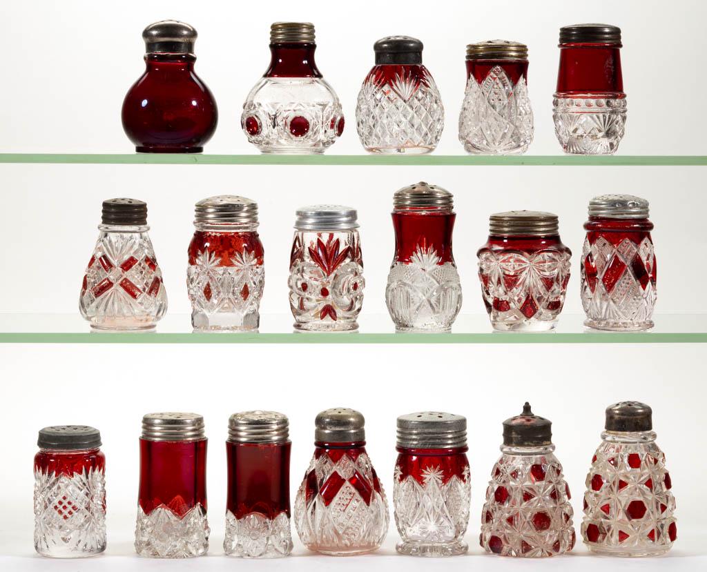 ASSORTED EAPG - RUBY-STAINED SALT AND PEPPER SHAKERS,: ASSORTED EAPG - RUBY-STAINED SALT AND PEPPER SHAKERS, LOT OF 18, colorless, including two Big Button, a Riverside's Victoria, a Cube with Fan, and a National's Eureka, each with likely period lid. Lat