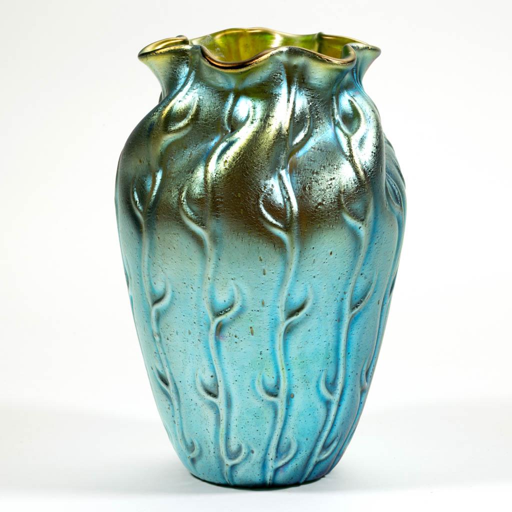 LOETZ ATTRIBUTED NEPTUNE ART GLASS VASE: LOETZ ATTRIBUTED NEPTUNE ART GLASS VASE, green iridescent, ovoid form with the shoulder having pinched swirls, polished pontil mark. Bohemia, now Czech Republic. First quarter 20th century. 6 3/4" H.V