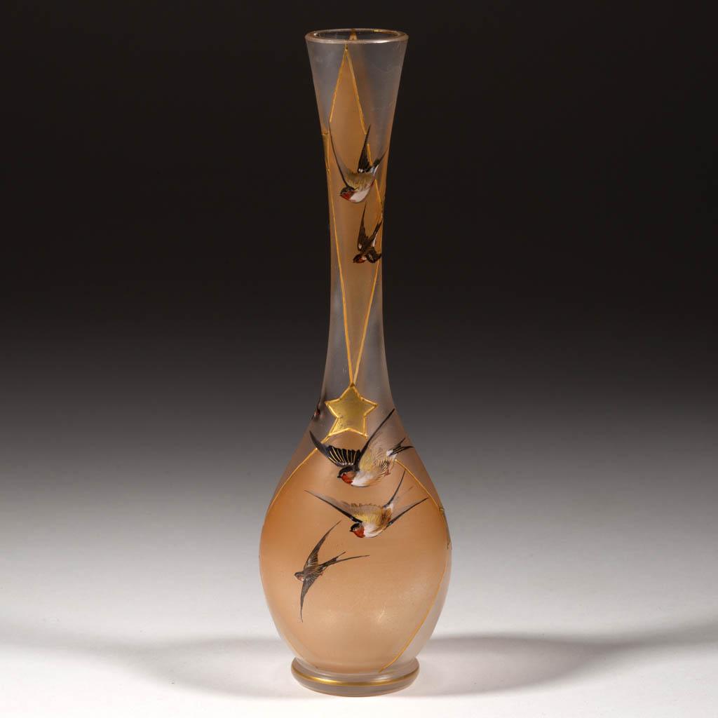 HARRACH ROYAL FLEMISH-STYLE ART GLASS BUD VASE: HARRACH ROYAL FLEMISH-STYLE ART GLASS BUD VASE, frosted colorless with polychrome-enamel decoration, depicting many flying birds in front of tan diamond with star-form connectors. Bohemia, now Czech R