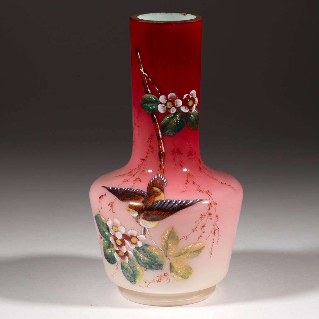 WEBB ENAMEL-DECORATED PEACHBLOW VASE: WEBB ENAMEL-DECORATED PEACHBLOW VASE, glossy with polychrome-enamel decoration, bottle form with decoration depicting a flying bird and flowers. Thomas Webb & Sons. Fourth quarter 19th century. 7 5/8"